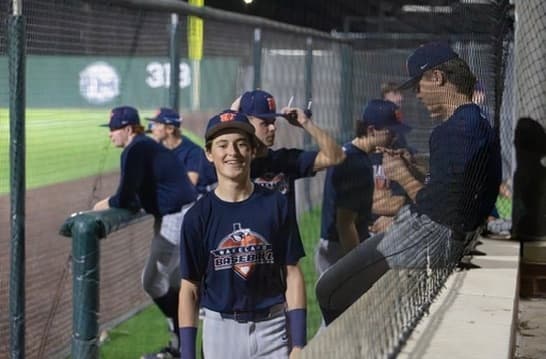 In the dugout with teammates